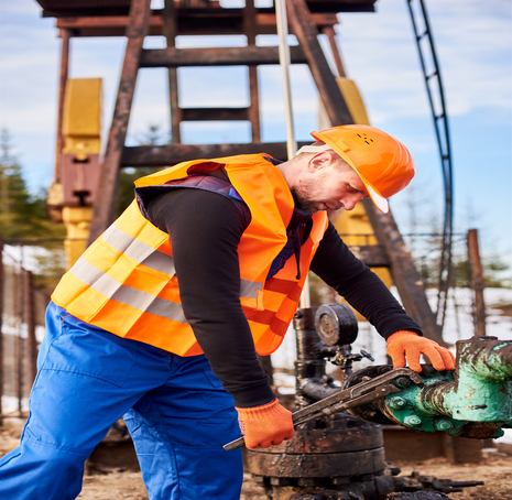 oil man tightening lug nuts with industrial wrench oil field 1